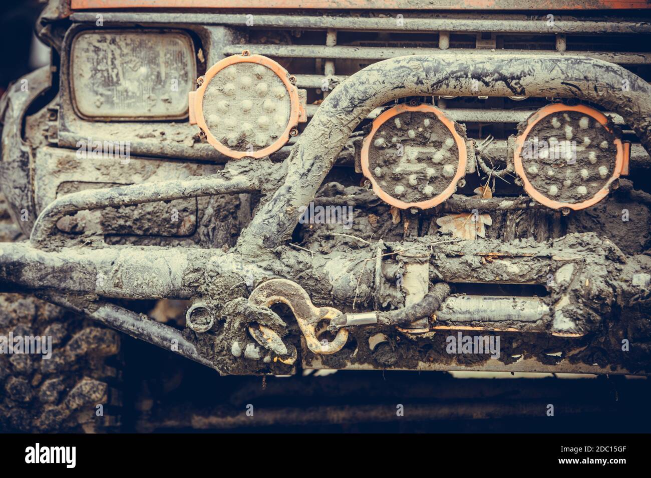 Close up shot of an off road car front, covered in mud, with bullbar