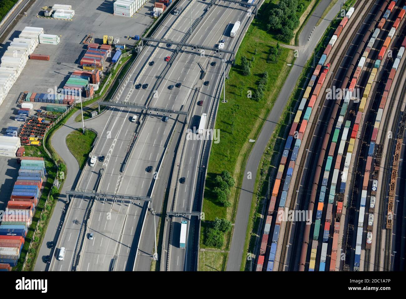 Germany, Hamburg, railway line for container transport from port and traffic on Autobahn / DEUTSCHLAND, Hamburg, Autobahn A7 und Bahnlinie Stock Photo