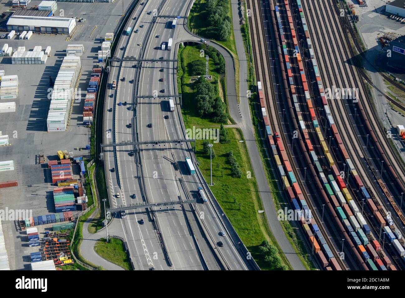 Germany, Hamburg, railway line for container transport from port and traffic on Autobahn / DEUTSCHLAND, Hamburg, Autobahn A7 und Bahnlinie Stock Photo