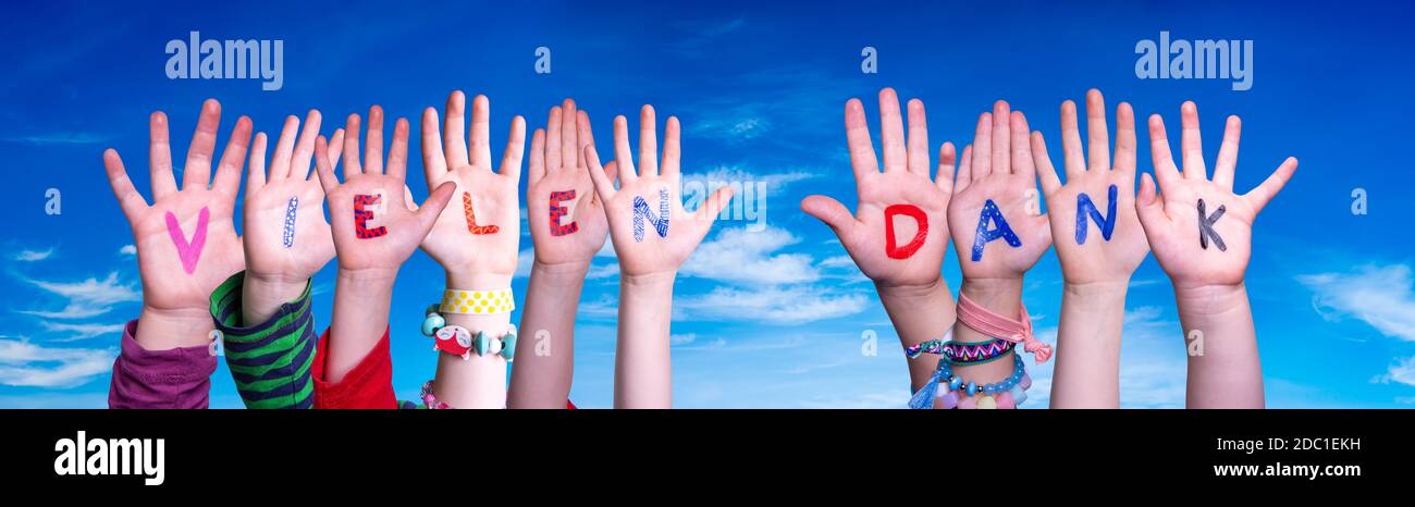 Children Hands Building Colorful German Word Vielen Dank Means Thank You. Blue Sky As Background Stock Photo