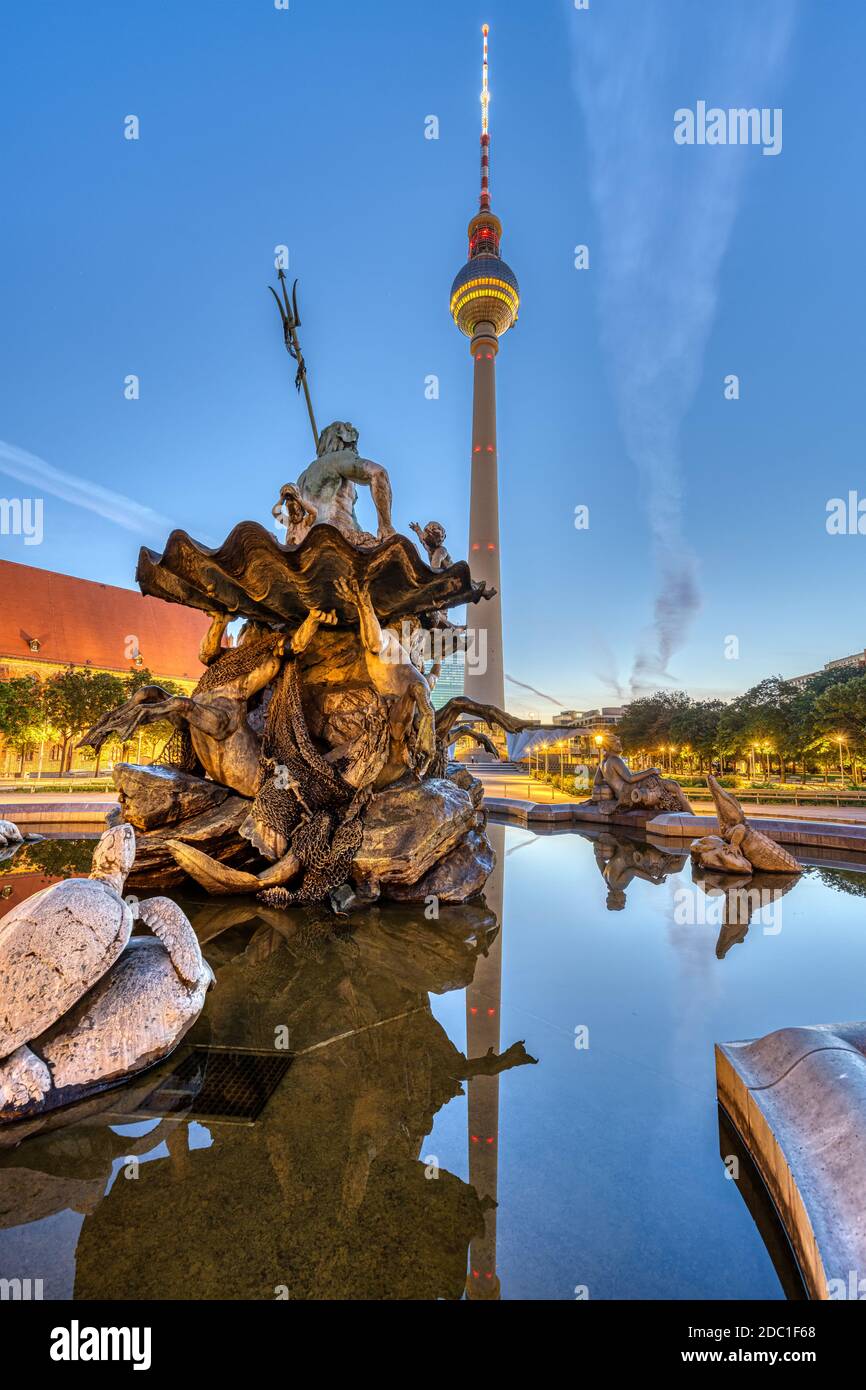The Television Tower and the Neptune fountain at Alexanderplatz in Berlin at dawn Stock Photo