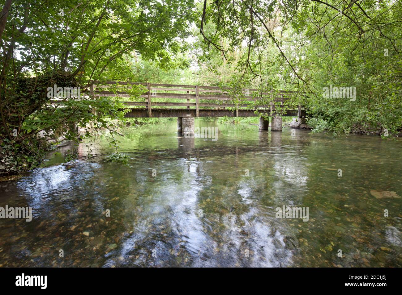A footbridge on the River Wylye at Sherrington in Wiltshire. Stock Photo
