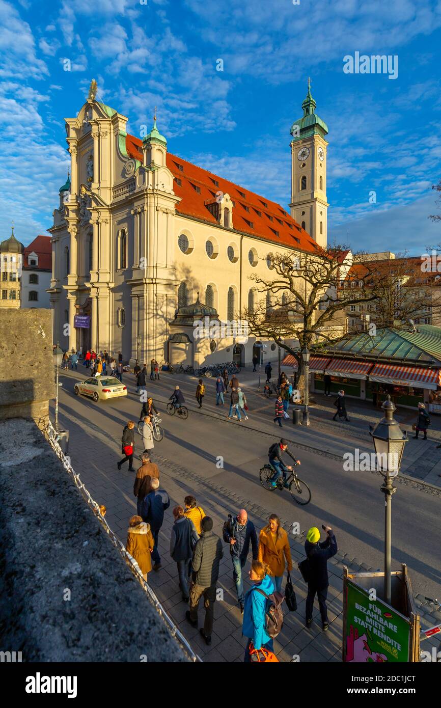 View of market and Heiliggeistkirche Church clock tower, Munich, Bavaria, Germany, Europe Stock Photo