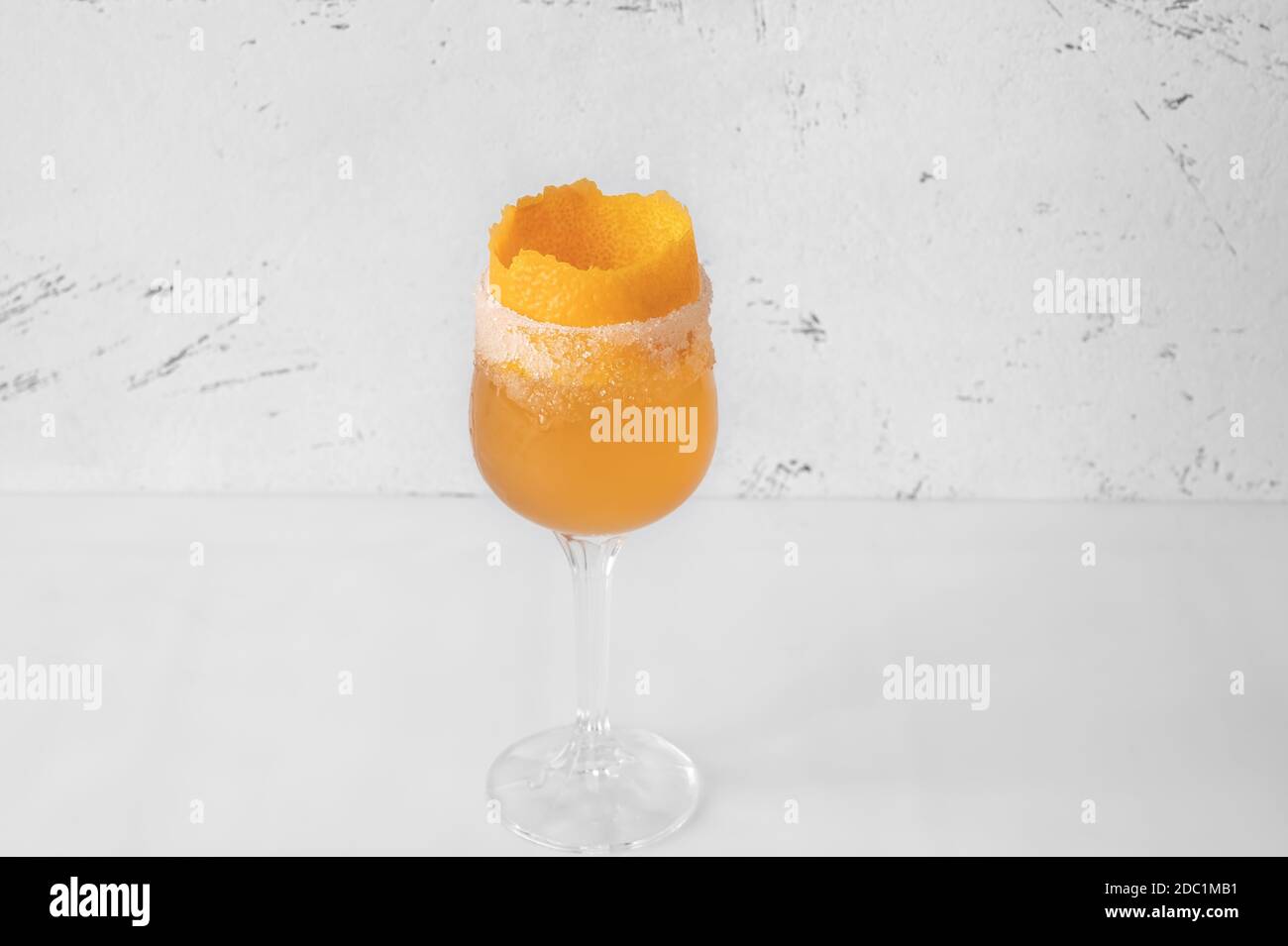 Glass of Brandy Crusta cocktail garnished with orange zest Stock Photo