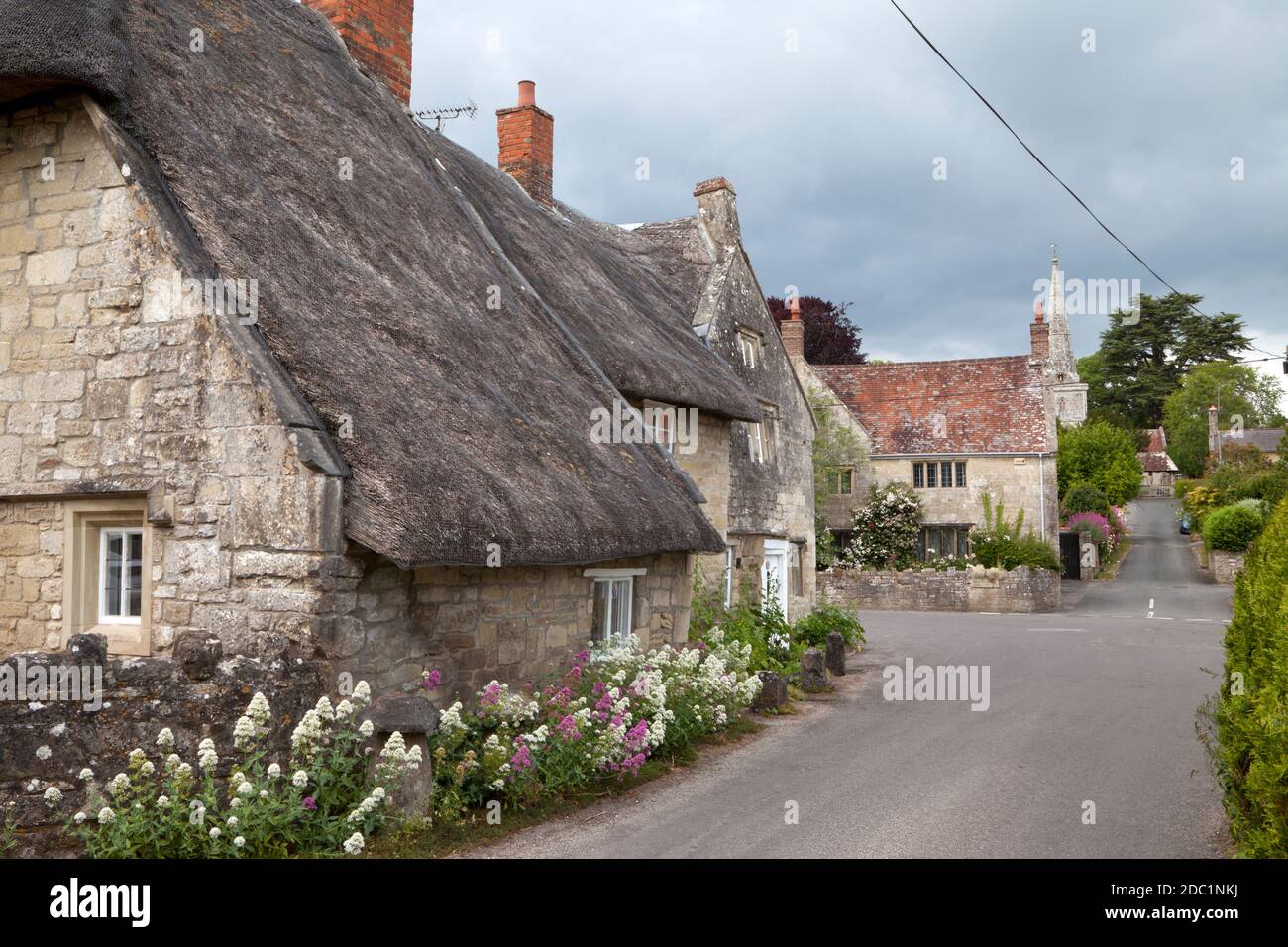 Thatched cottages in the village of Chilmark in Wiltshire. Stock Photo