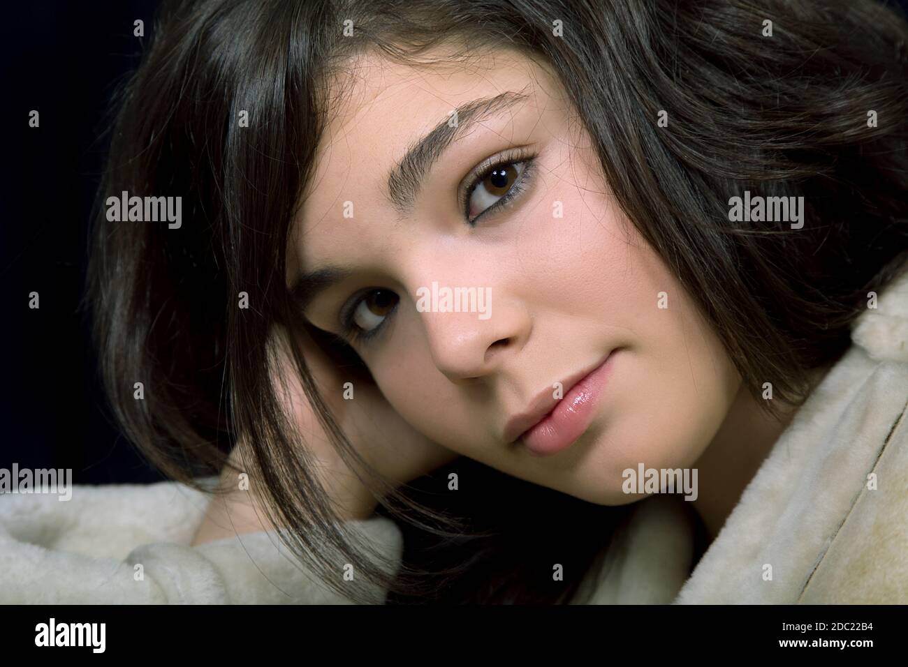 young beautiful brunette portrait against black background Stock Photo ...