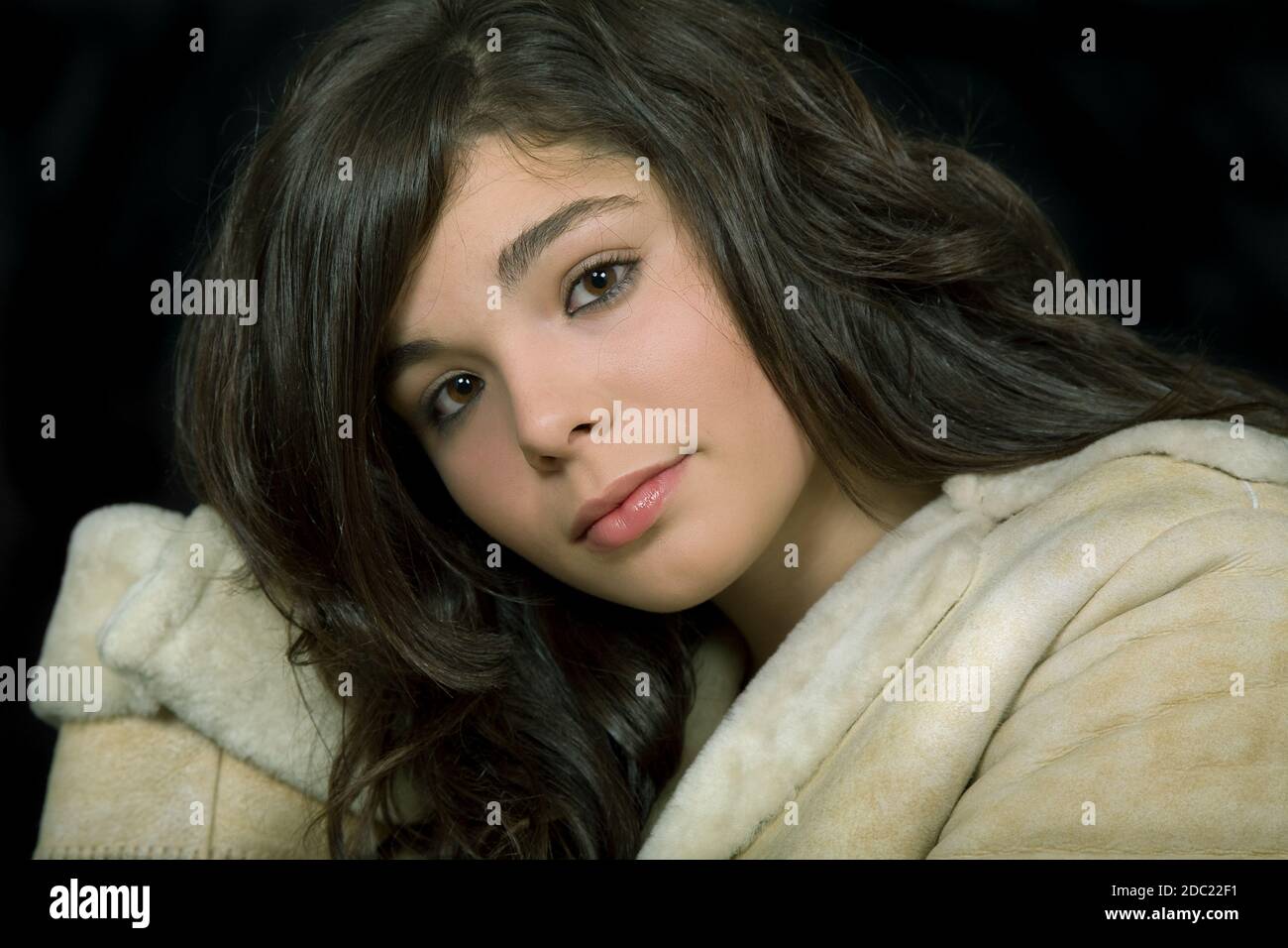 young beautiful brunette portrait against black background Stock Photo ...