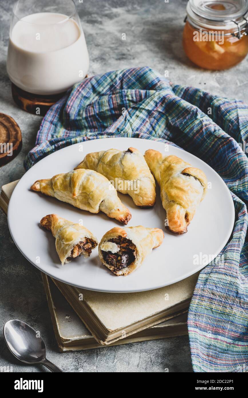 Fresh baked chocolate croissants with milk for breakfast Stock Photo