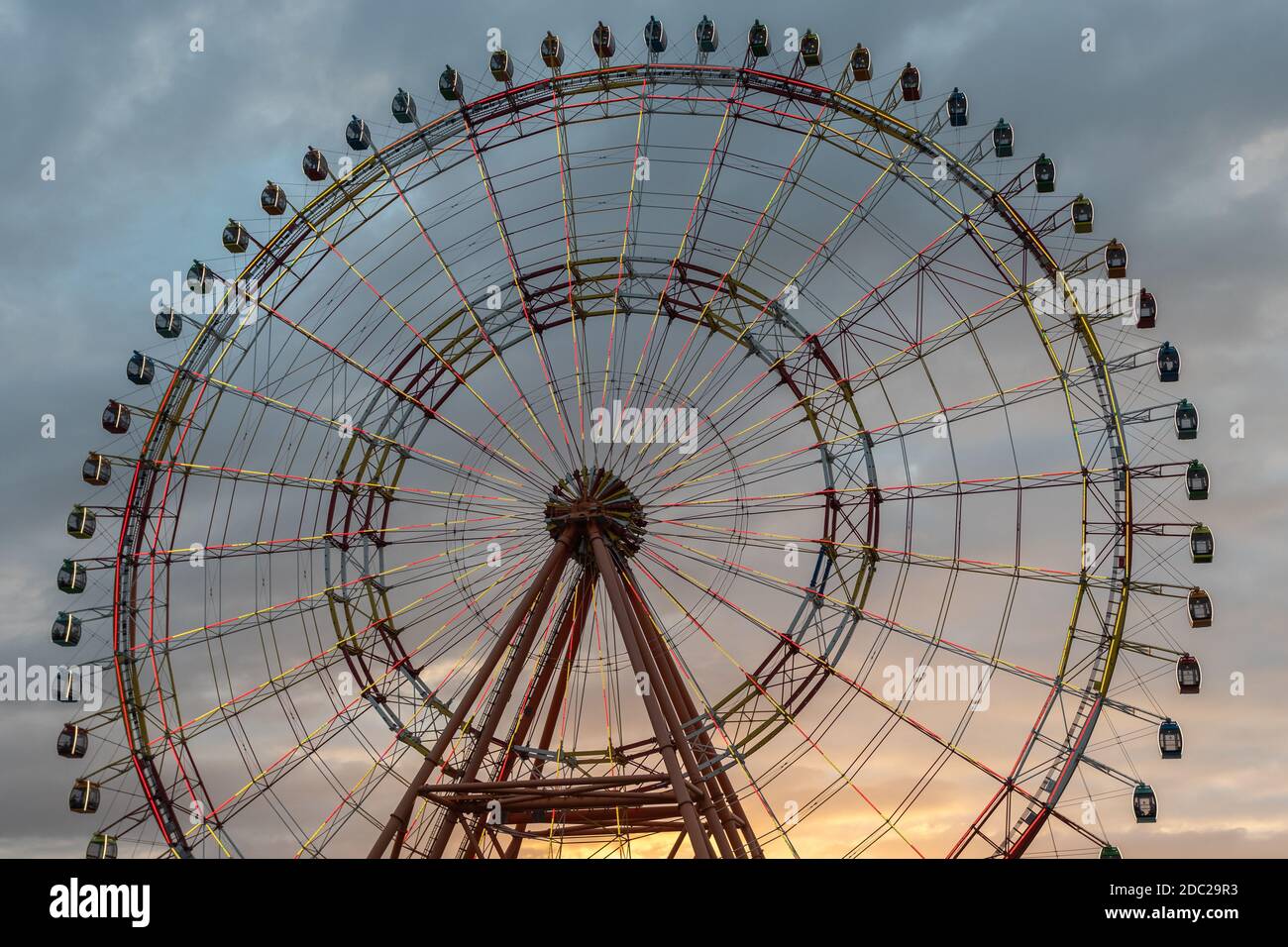 Ferris wheel against the background of a beautiful sunset sky. Stock Photo