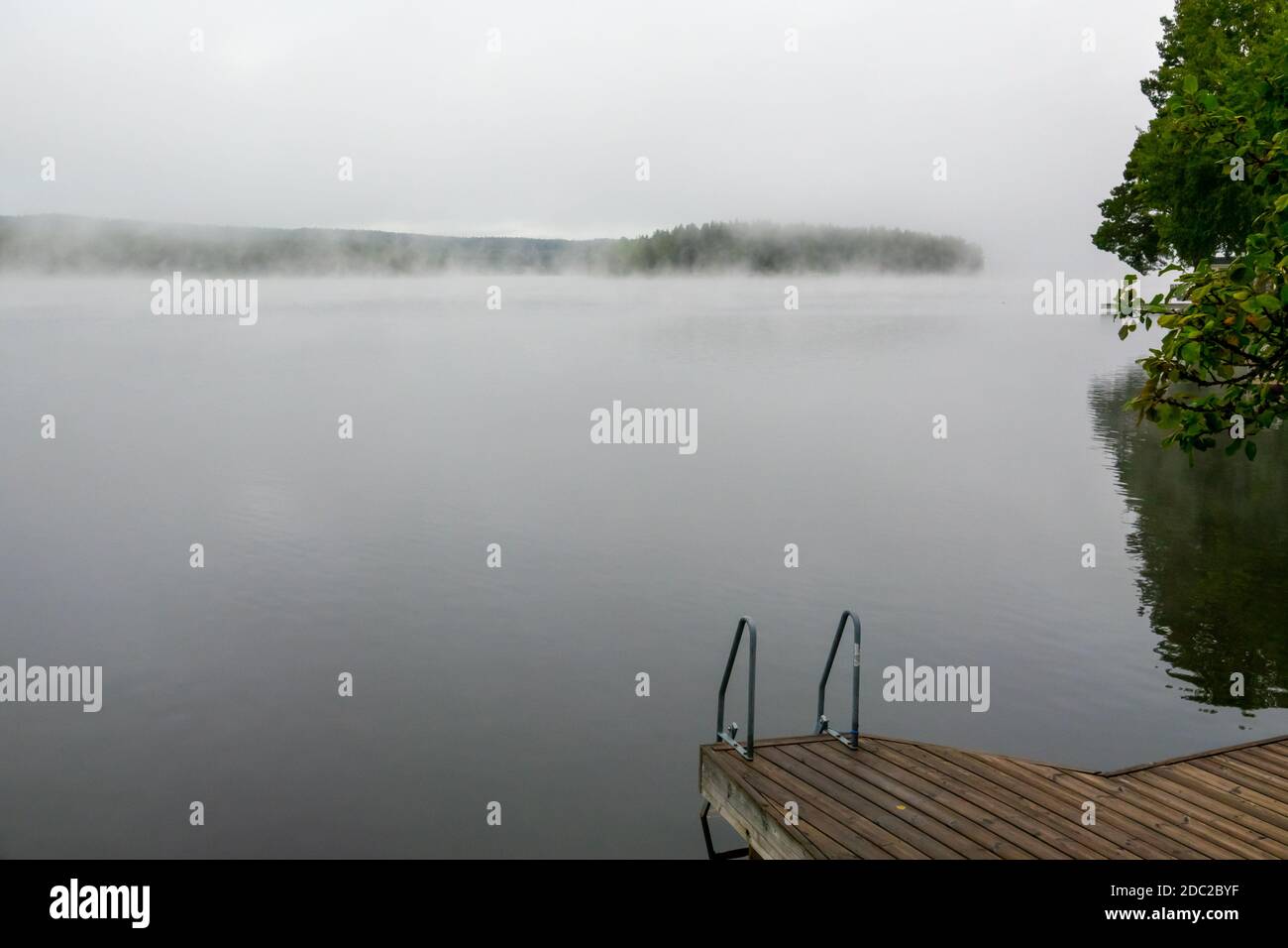 Misty morning at a lake during sunrise Stock Photo - Alamy