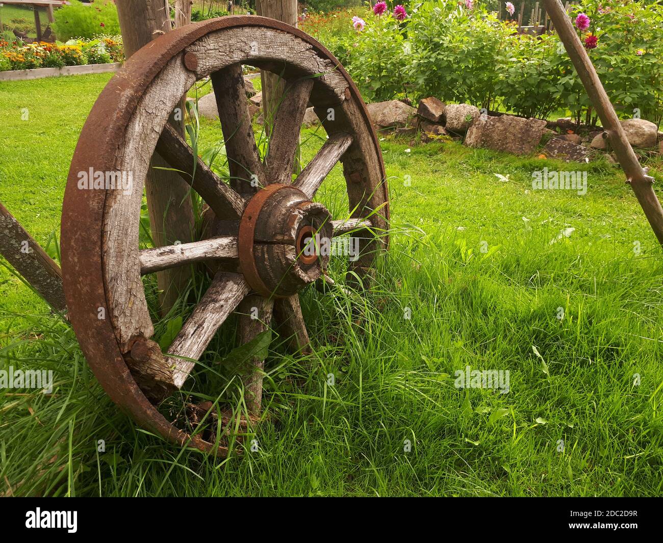 old wooden wheel on a green meadow - Bogstad GÃ¥rd Stock Photo