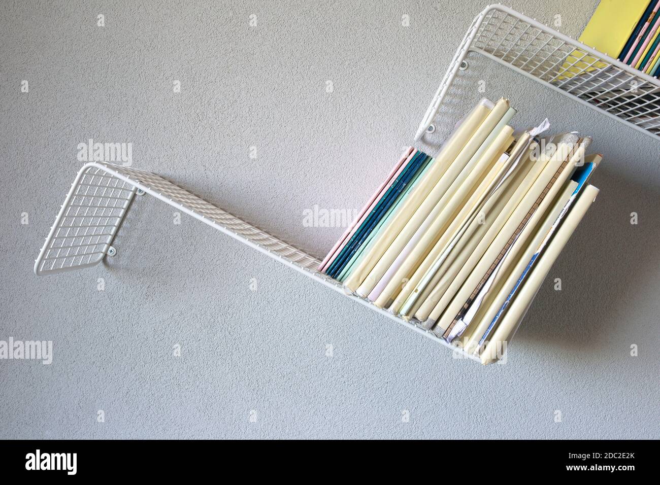 Modern iron rack bookshelf hanging on the wall with school books modern