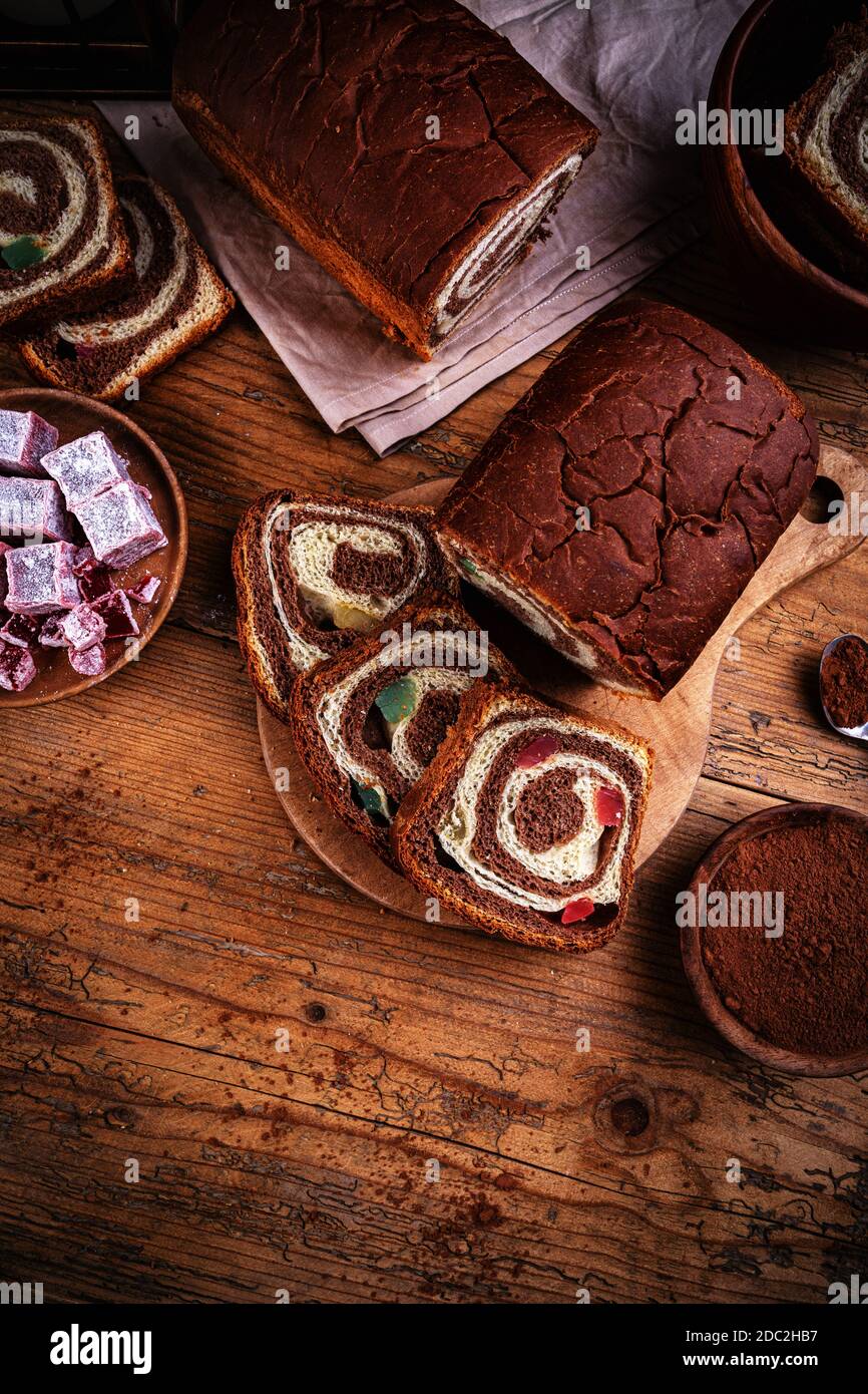 Swirl brioche with cocoa and Turkish delight on wooden background Stock Photo