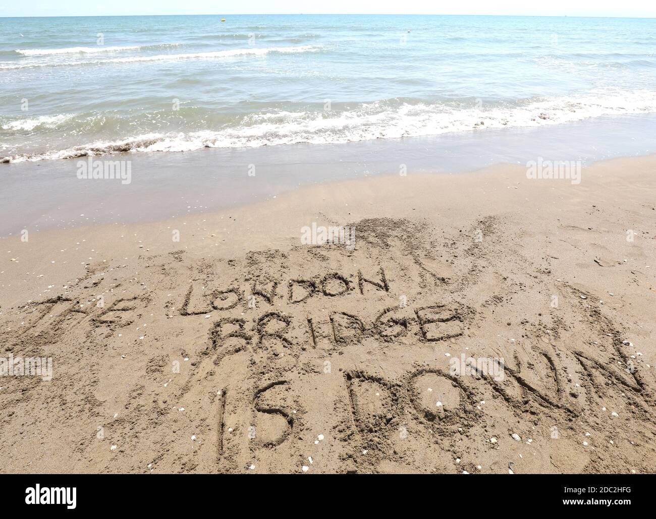 london bridge is down which is the name of the operation when the Queen of England dies written on the beach Stock Photo