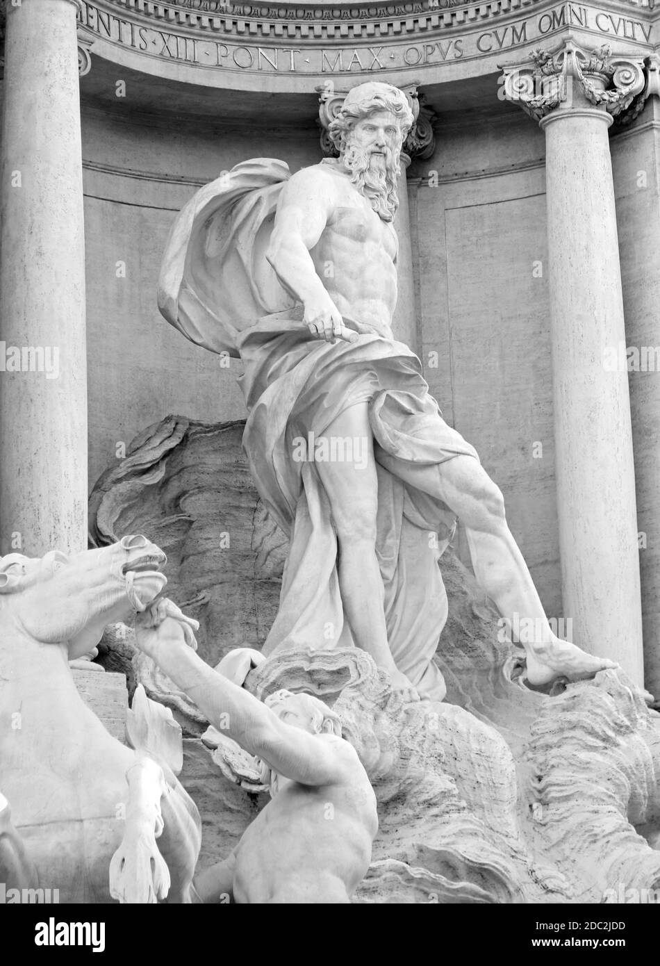 statue of the God Neptune in the Trevi fountain in Rome with black and white effect to enhance the shapes given by the sculptor Stock Photo