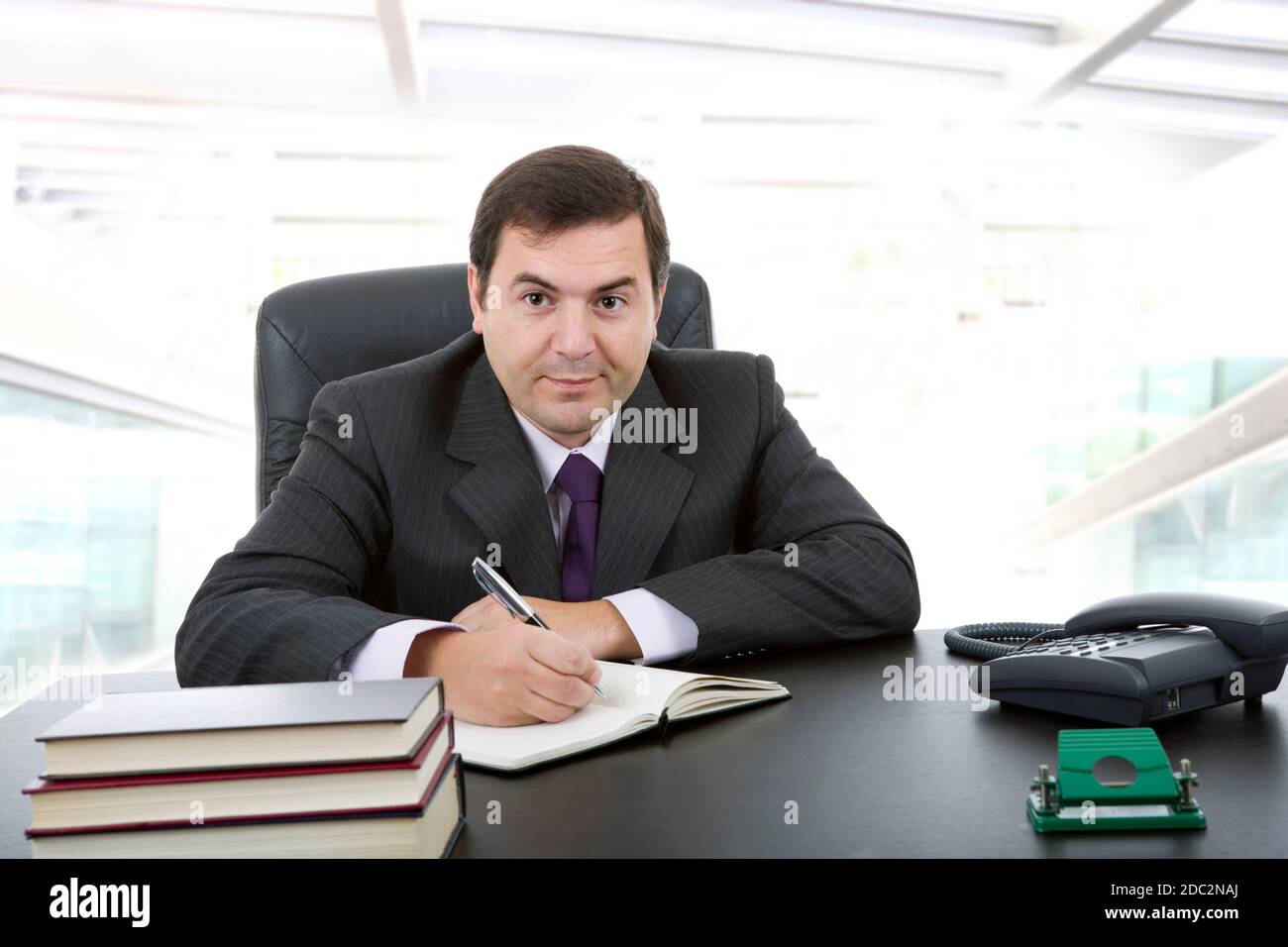 businessman writing on a desk, at the office Stock Photo - Alamy