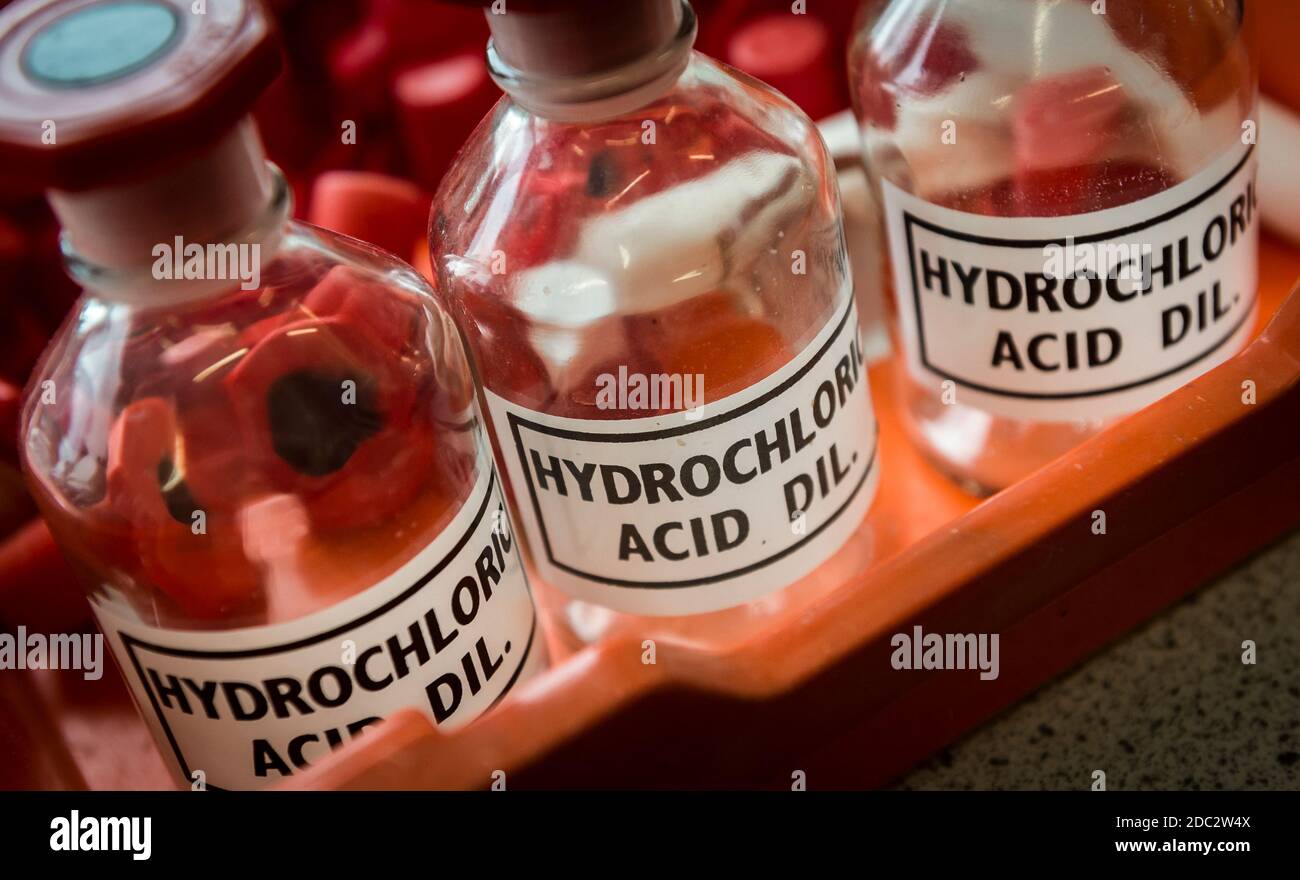 Hydrochloric acid bottles in a science laboratory in a college in England, UK. Stock Photo
