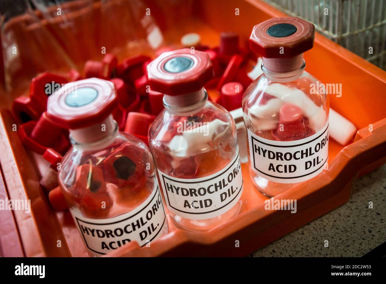 Hydrochloric acid bottles in a science laboratory in a college in England, UK. Stock Photo