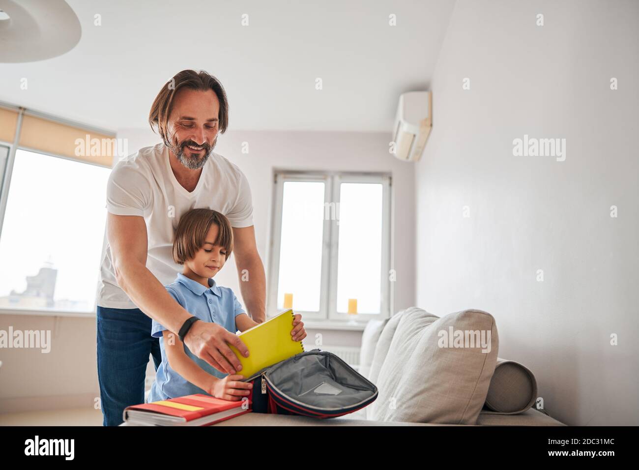 Joyful father taking part in his son school preparation Stock Photo