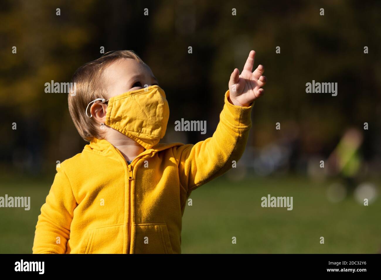 A young boy wearing a mask while playing in the park Stock Photo - Alamy
