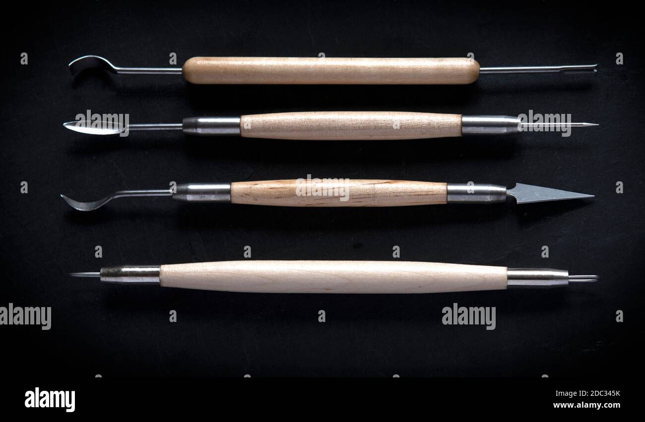group of pottery tools for clay crafting  flat lay design shot for text background  with dark slate Stock Photo