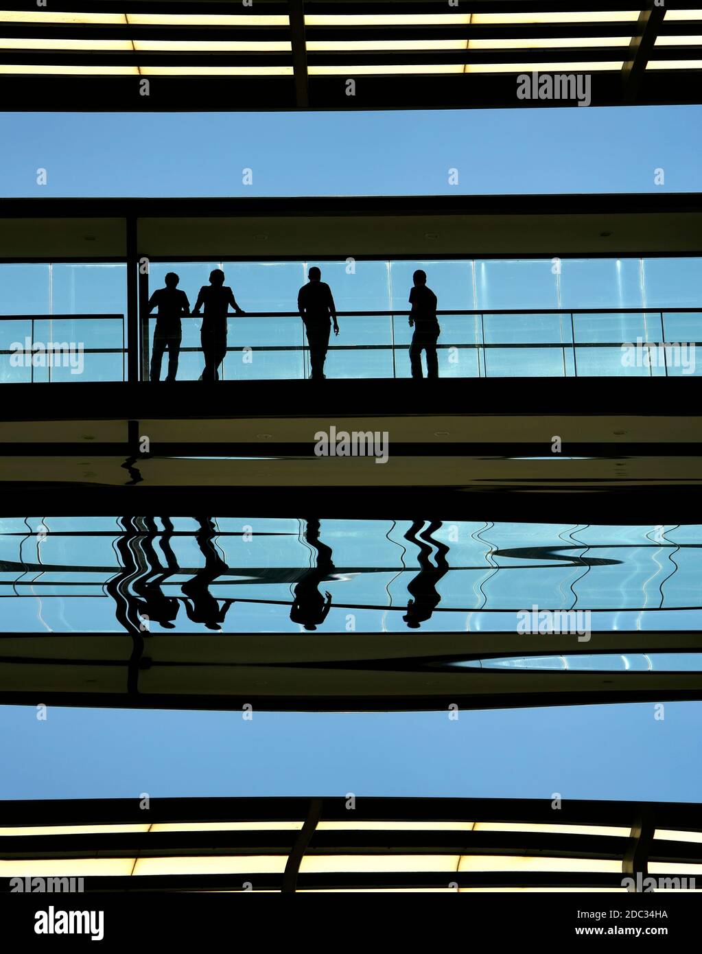 workers inside the modern building in silhouette Stock Photo