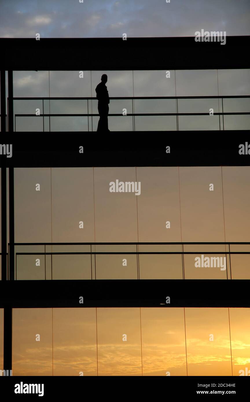 worker inside the building silhouette at sunset Stock Photo