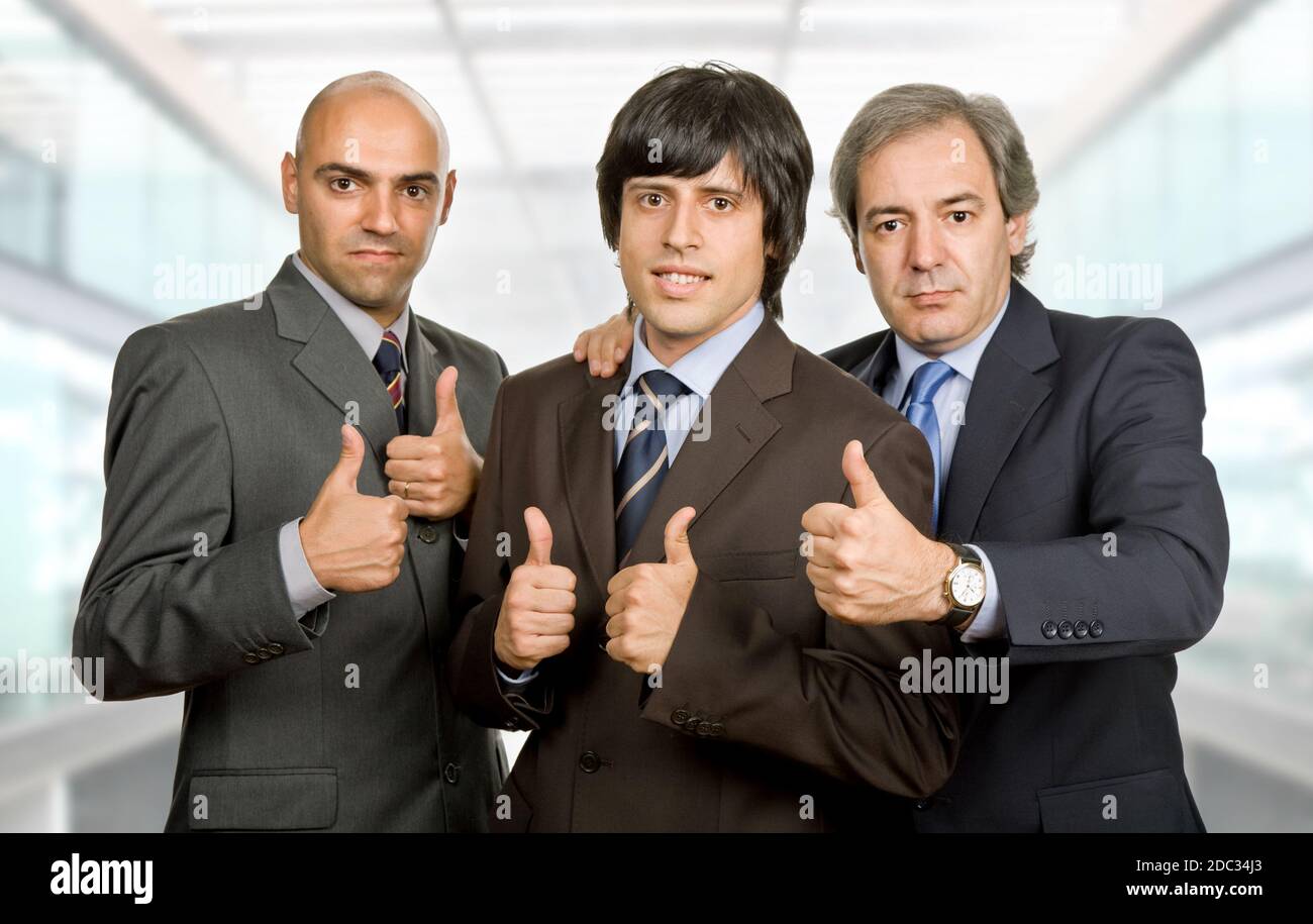 three young business men going thumbs up, at the office Stock Photo - Alamy