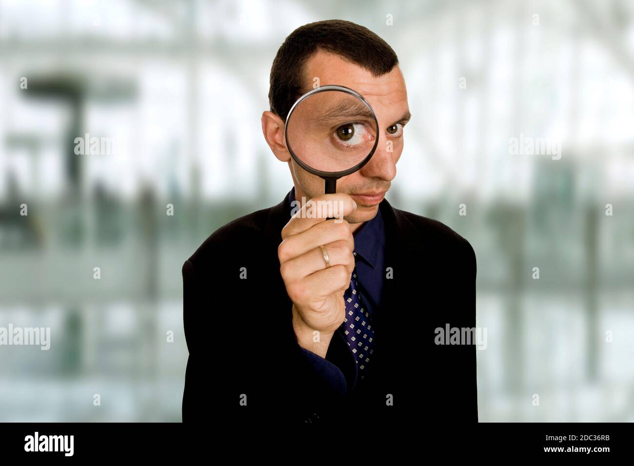 business man with a loupe at the office Stock Photo - Alamy