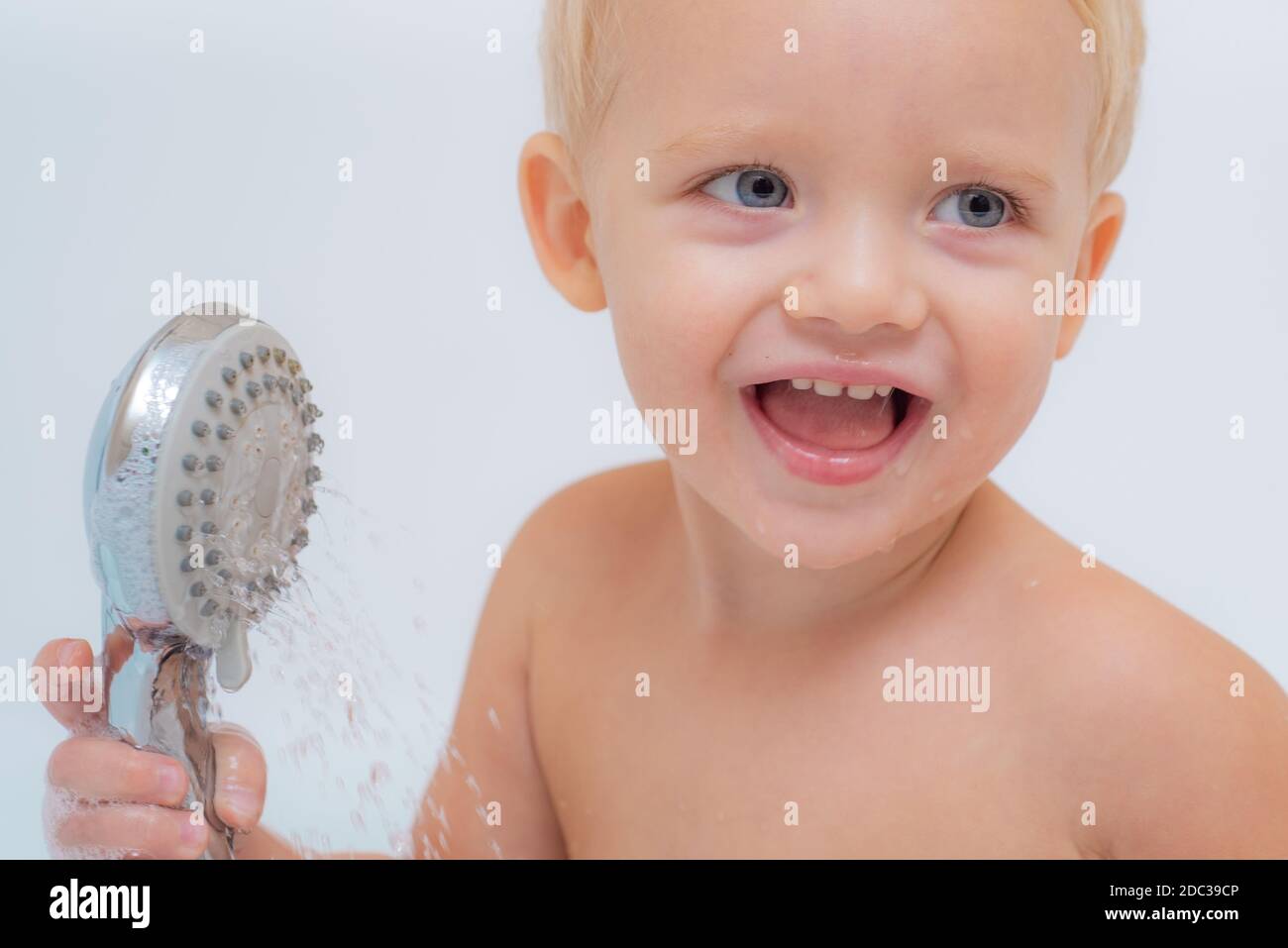 Child bubble bath. Pretty smiling little boy taking a bath with soap