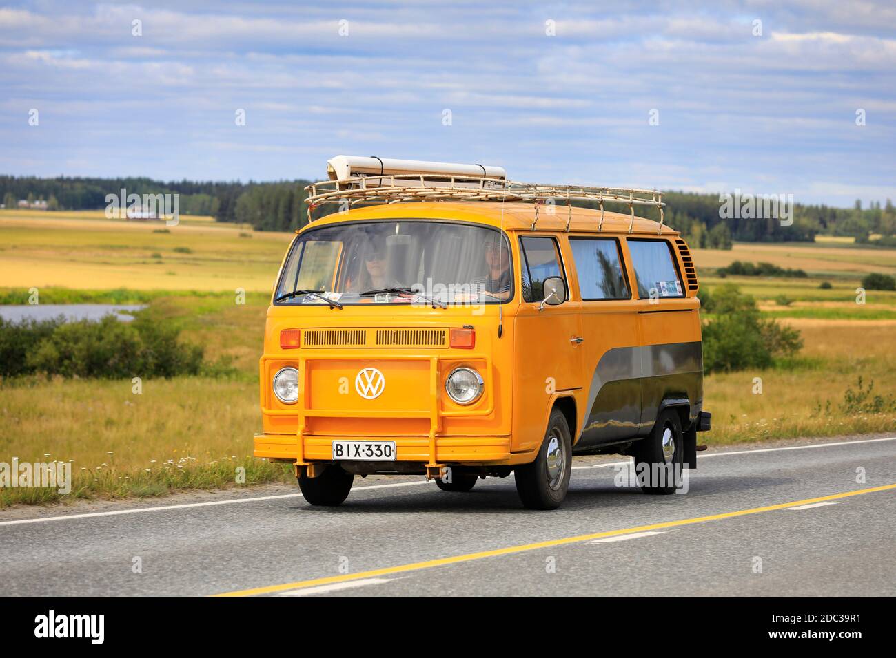 Yellow grey Volkswagen VW Type 2 camper van with grille guard and luggage rack on Maisemaruise 2019 car cruise. Vaulammi, Finland. August 3, 2019. Stock Photo