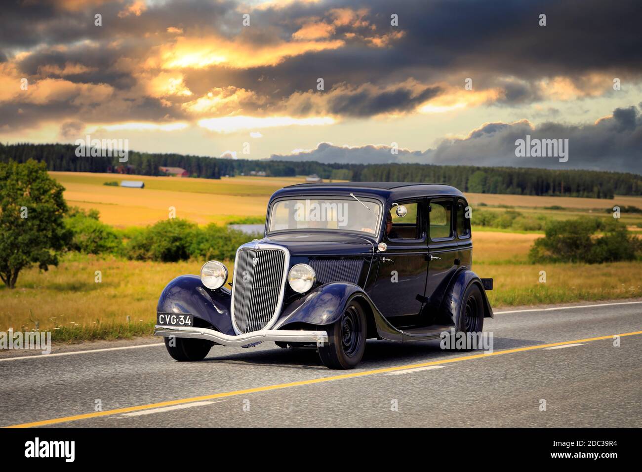 Black Ford Fordor Dillinger Special year 1934 on road on Maisemaruise 2019 car cruise. Edited sky. Vaulammi, Finland. August 3, 2019, Stock Photo