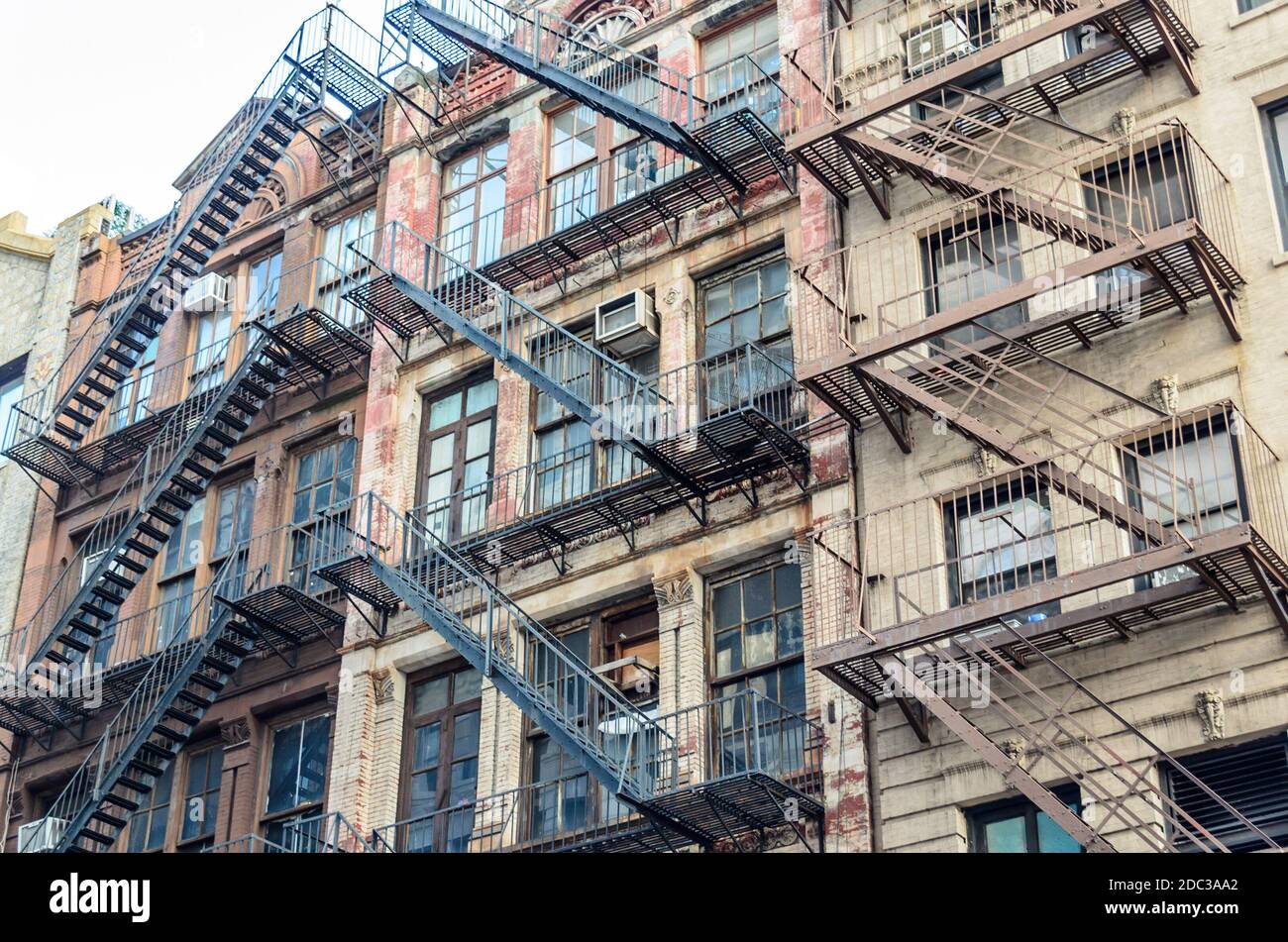 Low Angle View of Typical Apartment Buildings with Fire Escape Ladders in Manhattan,  New York City, USA Stock Photo
