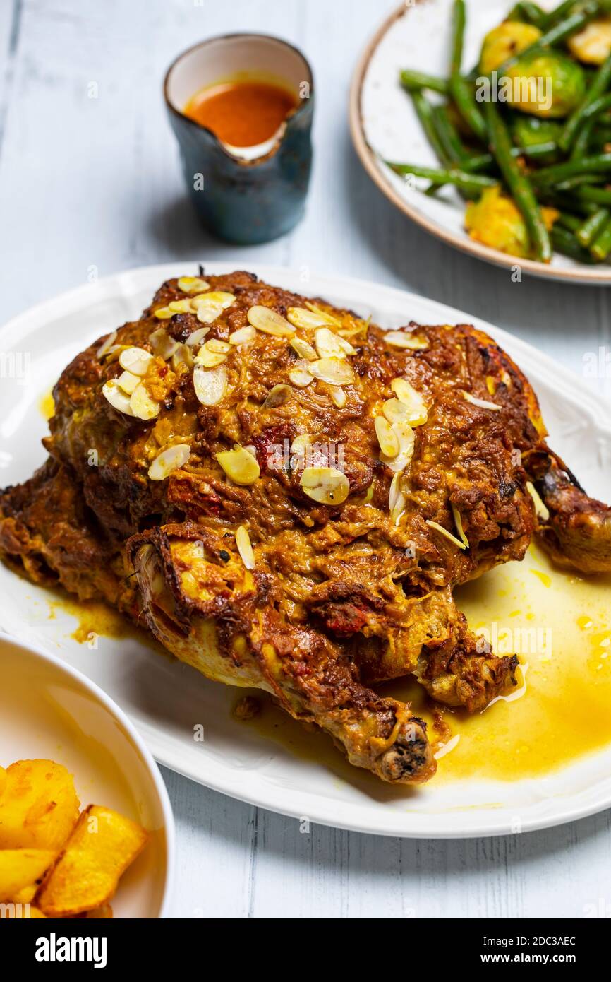 Whole roast chicken with Indian spices and yogurt and almond masala