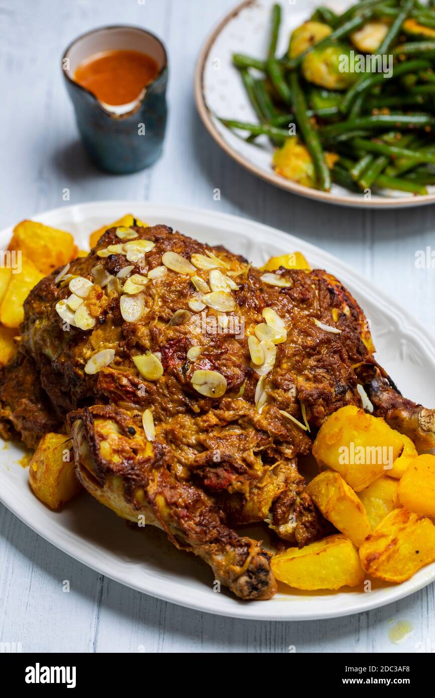 Whole roast chicken with Indian spices and yogurt and almond masala