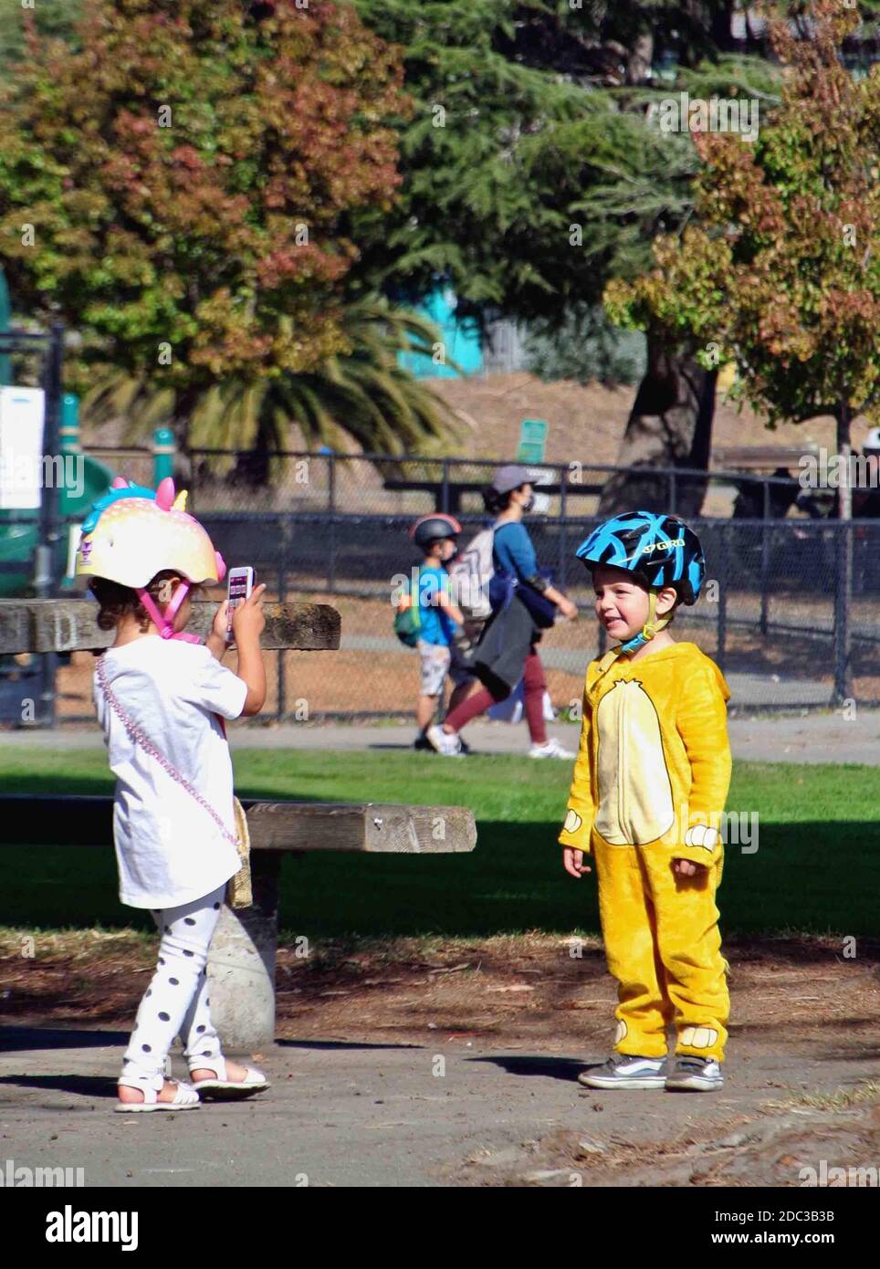 two kids about 8 years old take selfies during their play in sausalito california park Stock Photo