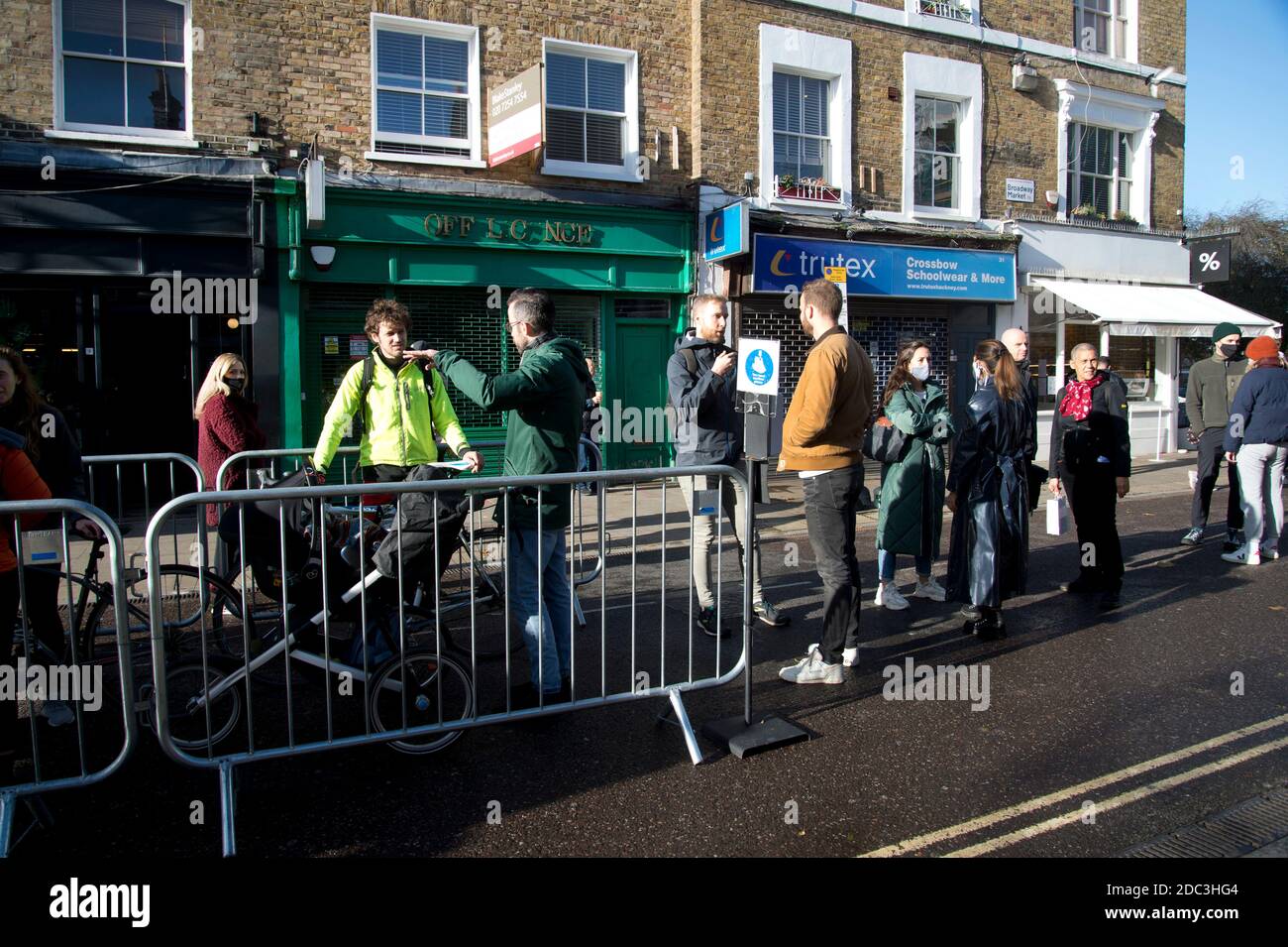 Hackney,London November 2020 during the Covid-19 (Coronavirus) pandemic. Lockdown 2. Broadway Market. People wearing face masks wait to enter an area Stock Photo