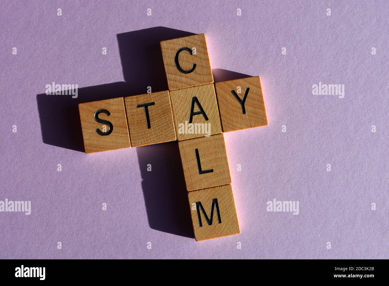 Stay Calm, words in wood alphabet letters on purple background Stock Photo