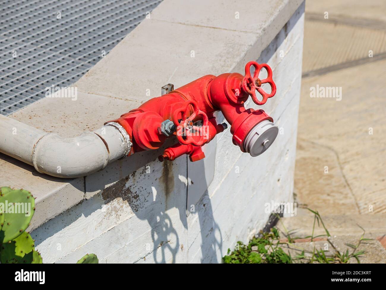 Old red fire hydrant in the street. Fire hidrant for emergency fire access Stock Photo