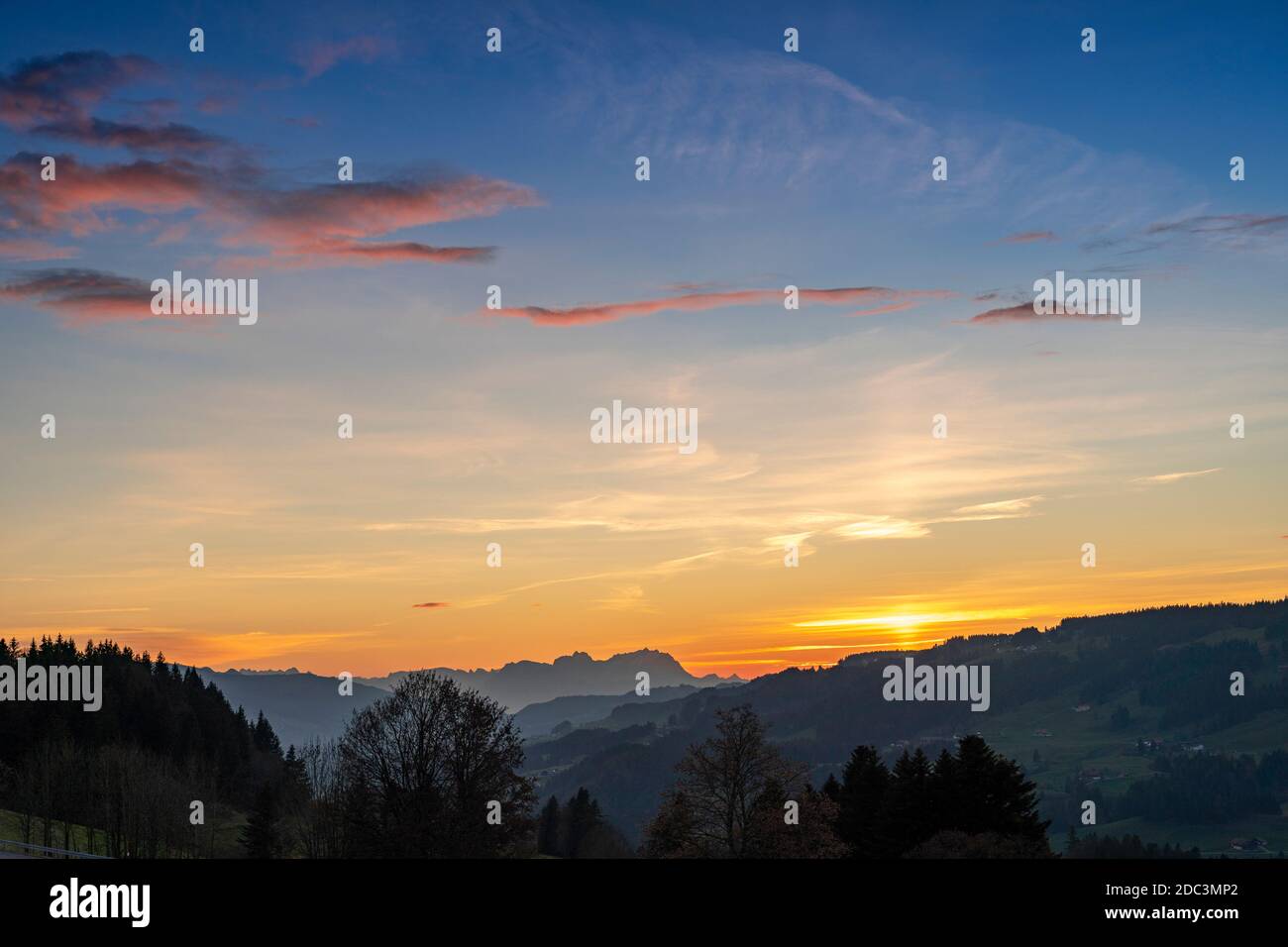 Sunset over Mount Saentis in Swiss Alps with Bregenzerwald, Austria, Vorarlberg, in foreground Stock Photo