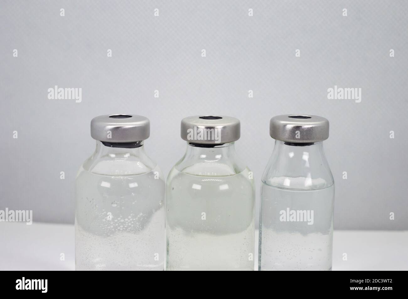 Three Vaccine vials against virus Stock Photo