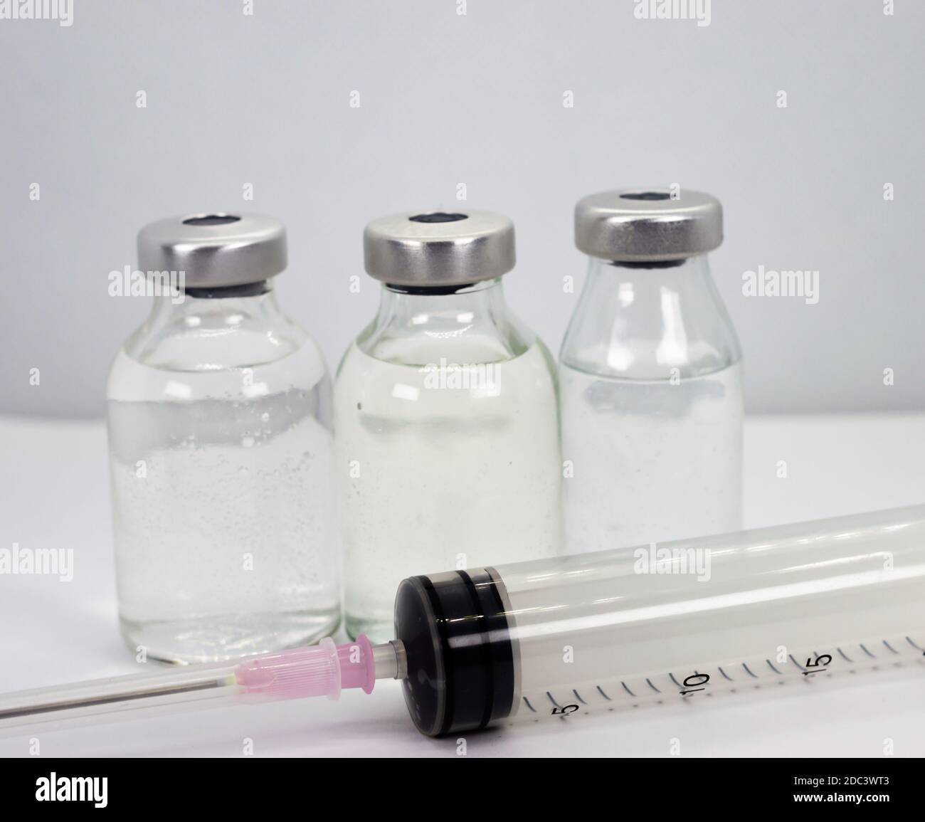 Vaccine vials and syringe on white background Stock Photo - Alamy