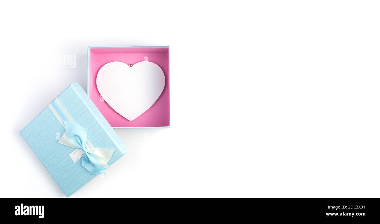 Open gift box with a white heart inside on a white background. Stock Photo