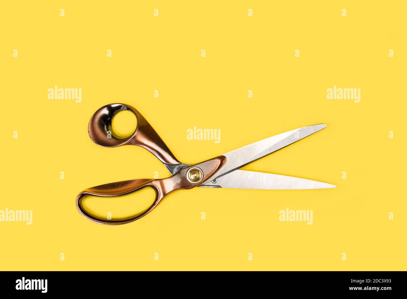 Tailor scissors on a yellow background in a top view Stock Photo