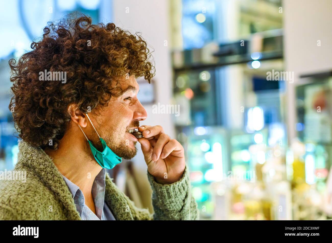 Young Happy Bearded Man With Healthy Skin And Curly Hair Pleasured With Taste Of Organic Freshly Baked Chocolate Holds One Small Piece In One Hand Stock Photo Alamy