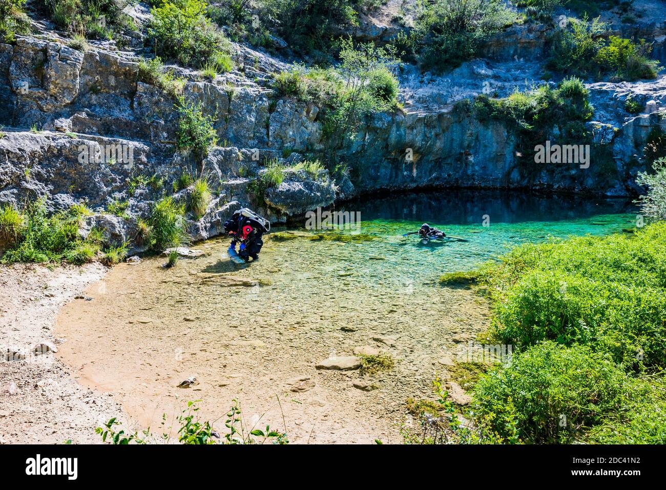 Divers in Pozo Azul. Underwater Speleology. Pozo Azul is a spring or upwelling of water located in the Burgos town of Covanera. Covanera, Tubilla del Stock Photo