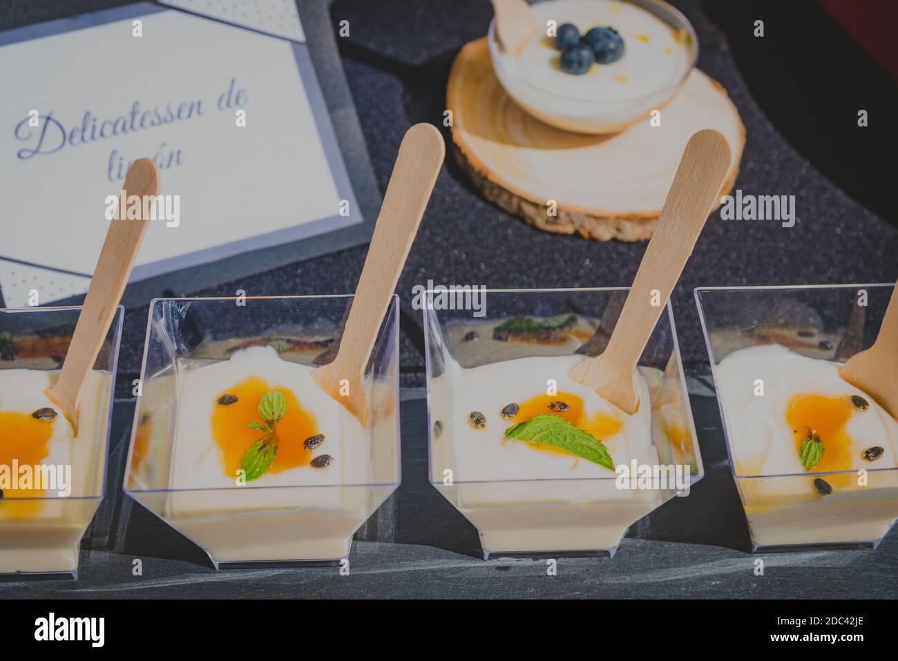 dessert in square glasses on a table and wooden spoons Stock Photo - Alamy