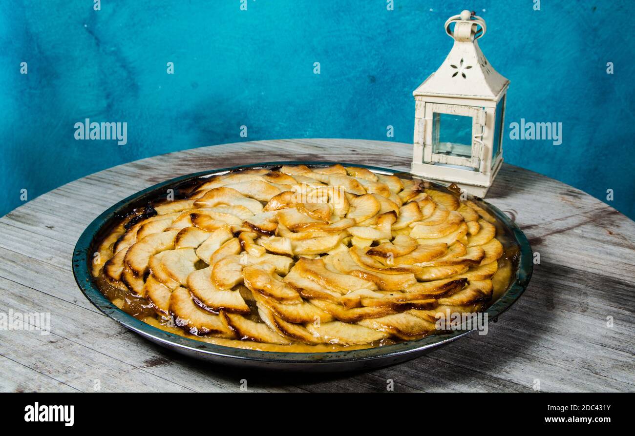 non-industrial handmade apple pie with a blue colored background Stock Photo