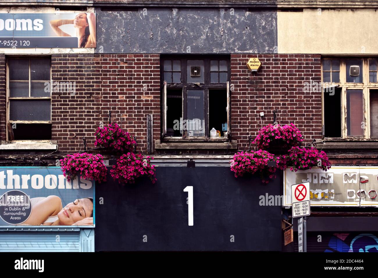 Giant, bold, big, number one 1, advertising signs on the facade of a brick building, Close up. Dublin, Republic of Ireland, Europe, European Union, EU Stock Photo