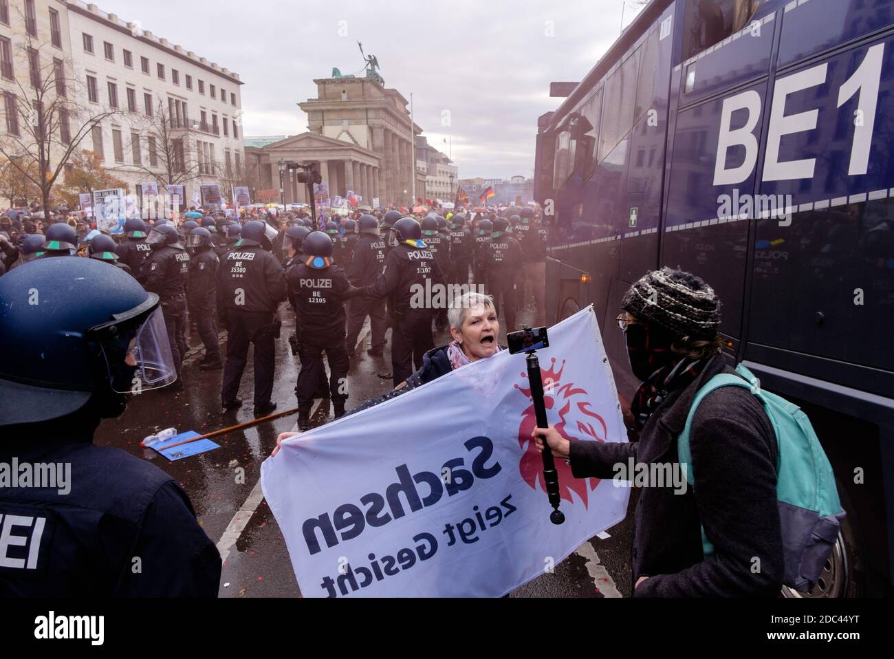 Berlin, Berlin, Germany. 18th Nov, 2020. Police officers try to displace protesters during the use of water cannons in front of Brandenburg Gate after heterogeneous groups around Corona deniers, conspiracy theorists and right-wing extremists called for blocking access to German Government Buildings. Both the Bundestag and the Bundesrat vote on planned new regulations of the infection protection law on November 18, 2020. Credit: Jan Scheunert/ZUMA Wire/Alamy Live News Stock Photo